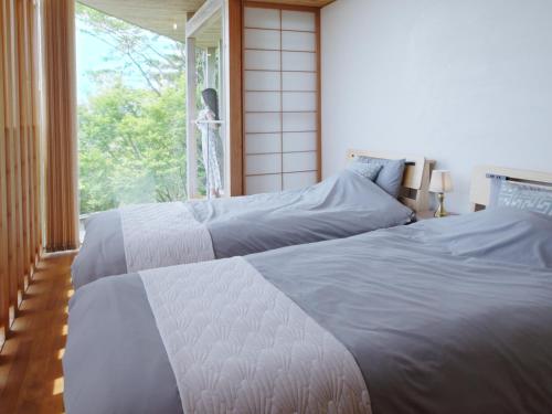 Postel nebo postele na pokoji v ubytování resort villa COTEAU
