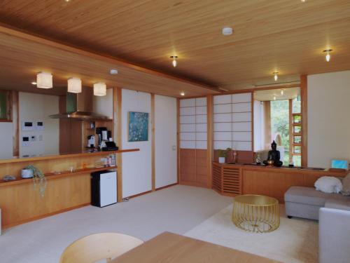 a living room with a couch and a table at resort villa COTEAU in Konan