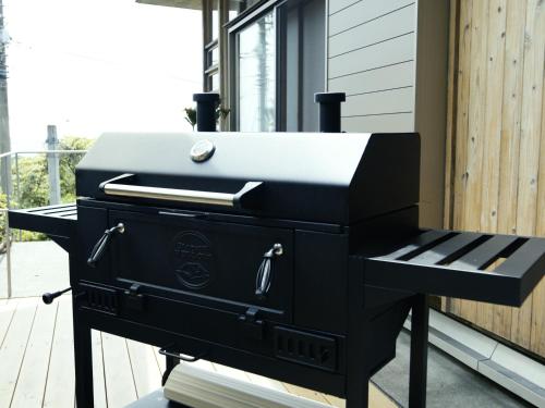 a barbecue grill sitting on a porch at resort villa COTEAU in Konan