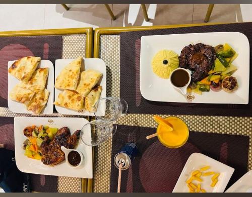 a table with three plates of food on it at Sayeman Heritage Residence in Cox's Bazar