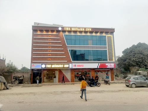 a man standing in front of a building at The Monark Inn in Sandīla