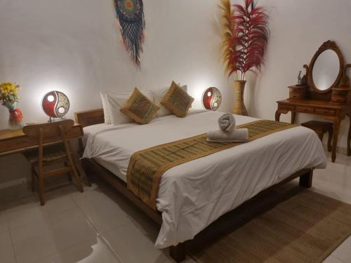 a bedroom with a bed with a statue on it at Umah Dewi Private Villa in Ubud