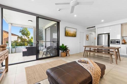 a living room with a couch and a table at Rockpools 3 in Sawtell