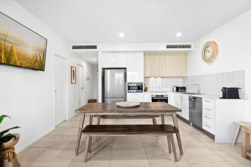 a kitchen with a wooden table in a room at Rockpools 3 in Sawtell