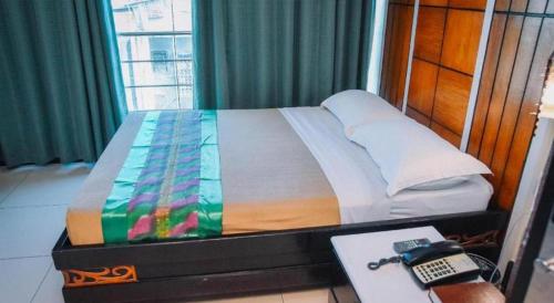 Postel nebo postele na pokoji v ubytování Marcian Business Hotel