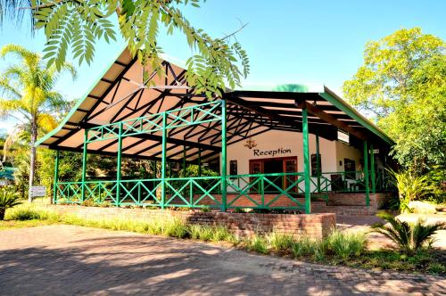 a building with a green and white roof at Tzaneen Country Lodge in Tzaneen