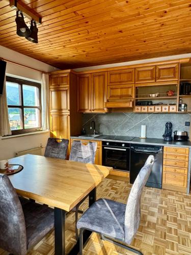 a kitchen with a table and chairs in a room at Apartmaji Lipa in Bohinj