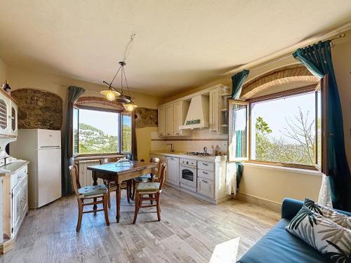 a kitchen with a table and chairs in a room at Agriturismo Casa Lavanda in Gabbro