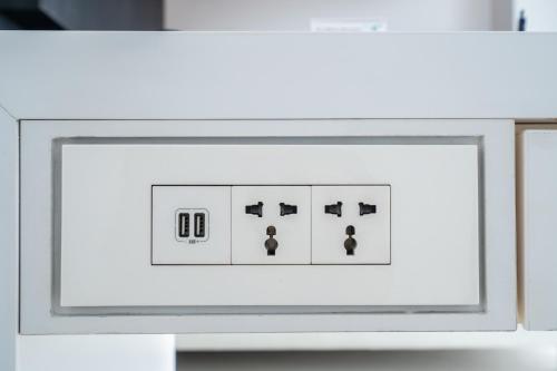 a white lightswitch on a white table at The Place Tainan in Tainan