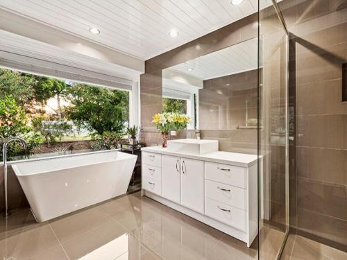 a bathroom with a tub and a sink and a shower at 410 Kangaroo ground 15 , 20 people restaurant in Kangaroo Ground