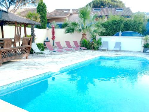 - une piscine avec 2 chaises dans l'établissement Détente au Rêve d'Azur, 1 chambre, plage à pied , piscine partagée, BBQ draps inclus, à Sainte-Maxime