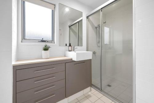 a bathroom with a sink and a shower at Beach Shacks 1 240m to Beach with Pool, Spa and Bbq in Casuarina