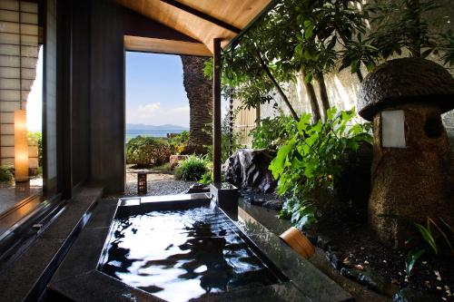 a koi pond in the middle of a house at Shunkeiroman Ginpaso in Gamagori