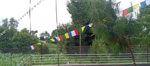 a group of flags hanging from a fence at Everest Home Stay Temal Kalimati Tower in Thapathali