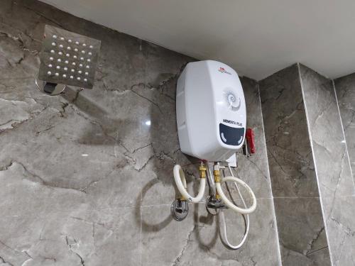 a hair dryer in a bathroom on a marble floor at Hotel MARUTI R Drive Inn Road in Ahmedabad