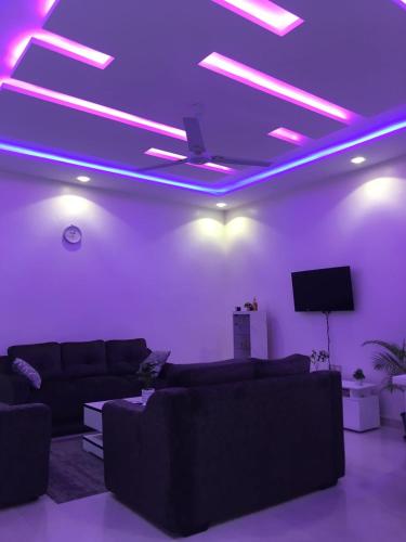 a living room with purple lights on the ceiling at Résidence Sekandji in Agbato
