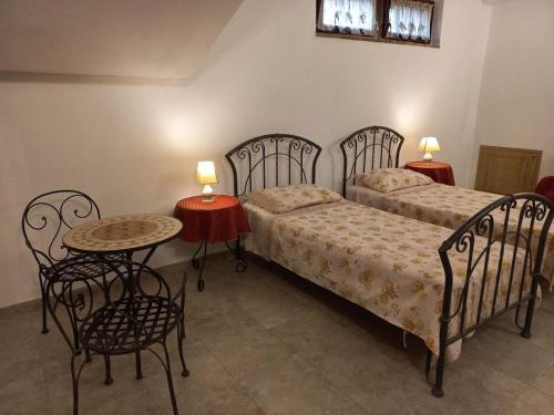 a bedroom with two beds and a table and chairs at Villa Annamaria in Torino di Sangro