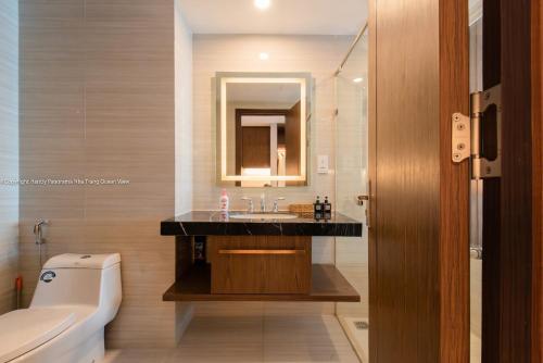 a bathroom with a sink and a mirror and a toilet at HD Panorama Nha Trang Condotel- 2 nguyen thi minh khai, nha trang in Nha Trang