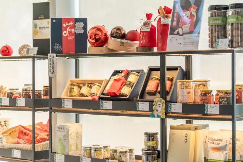 a store shelf filled with different types of food at The Place Tainan in Tainan