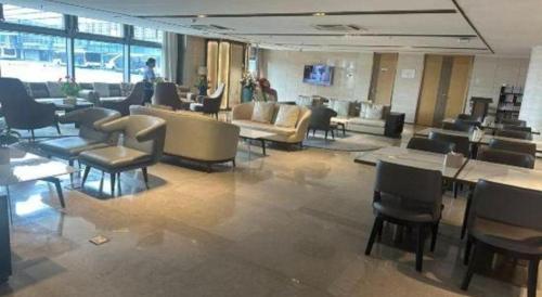 a lobby with couches and chairs in a building at Fliport Garden Hotel Nanjing in Nanjing
