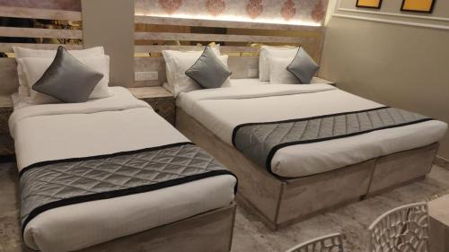 two twin beds in a room with at Vinttage park hotels in Bengaluru
