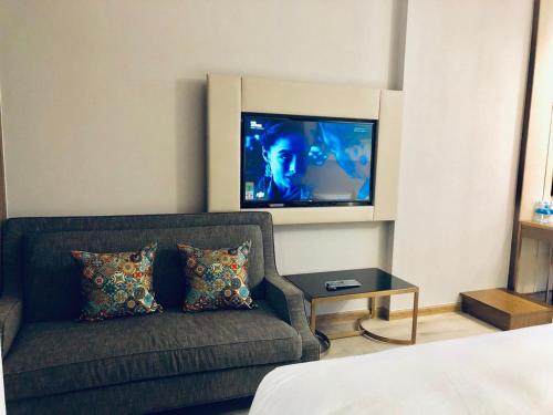 a living room with a couch and a flat screen tv at HD Panorama Nha Trang Condotel- 2 Nguyen Thi Minh Khai Nha Trang in Nha Trang