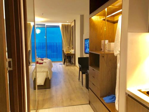 a hotel room with a bed and a desk and a bedroom at HD Panorama Nha Trang Condotel- 2 Nguyen Thi Minh Khai Nha Trang in Nha Trang
