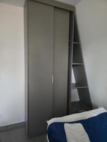 a bedroom with a bed and a large cabinet at Orion, Hills of Zaarour in Zaarour