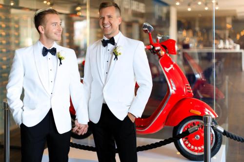 two men in white suits standing next to a red scooter at Andaz West Hollywood, By Hyatt in Los Angeles