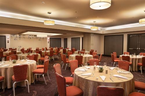 a conference room with tables and chairs and a screen at Hyatt Regency Boston in Boston