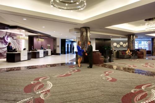 two people walking through a lobby of a hotel at Hyatt Regency Boston in Boston
