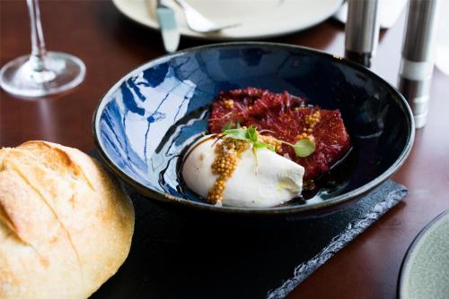 a blue bowl of food on a table with bread at Hyatt Regency Orlando International Airport Hotel in Orlando