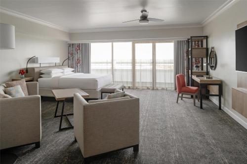 a hotel room with a bed and a desk and chairs at Hyatt Regency Orlando International Airport Hotel in Orlando
