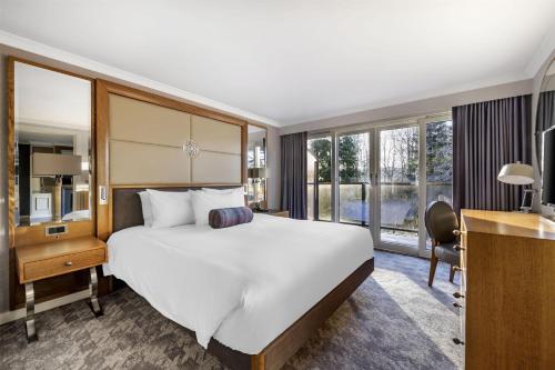 a hotel room with a large bed and a desk at Hilton Grand Vacations Club Craigendarroch Suites Scotland in Ballater