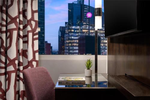 a room with a window with a view of a city at Hilton Garden Inn New York - Times Square Central in New York