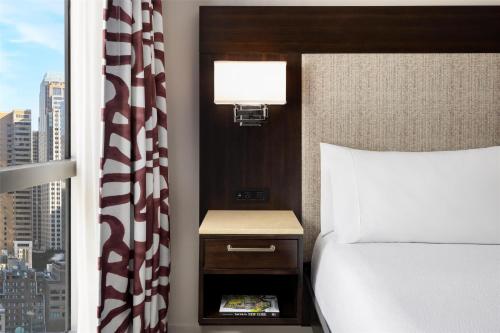 a hotel room with a bed and a window at Hilton Garden Inn New York - Times Square Central in New York