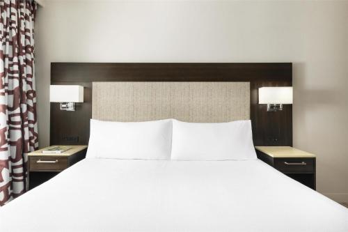 a bedroom with a large bed with two night stands at Hilton Garden Inn New York - Times Square Central in New York