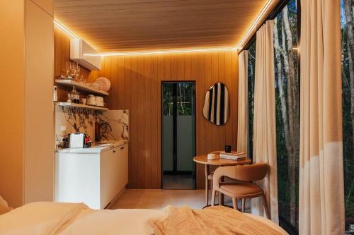 a room with a kitchen and a table in a room at Luxury Mirror Home in Byron Bay Hinterland in Binna Burra