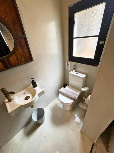 a small bathroom with a toilet and a sink at Industrial Cozy Gzira Apt, Prime Spot, Sep Deal in Il-Gżira