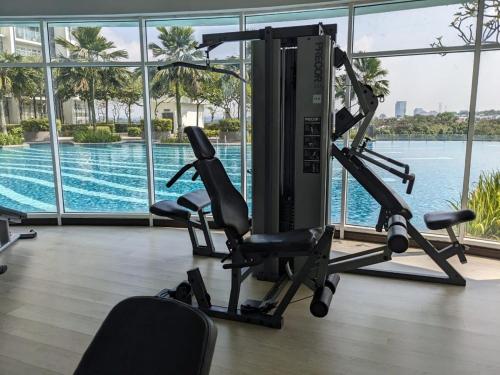 a gym with two treadmills and a swimming pool at Santaii Putrajaya #6pax Pool View in Putrajaya