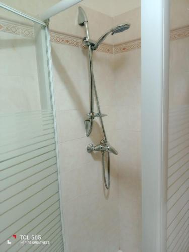 a shower with a shower head in a bathroom at Le Onde di Rossella in Torre Lapillo