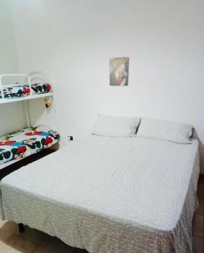 a bedroom with a bed and a shelf at Le Onde di Rossella in Torre Lapillo