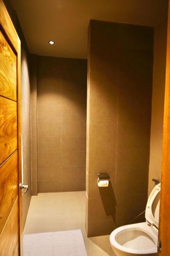 a small bathroom with a toilet and a sink at Mayfair Garden Resort in Panglao Island