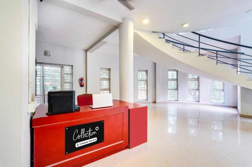 a large white room with a red counter with a tv on it at Collection O ECR Stays Near Nemmeli Beach in Chennai