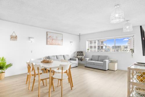 a living room with a table and chairs and a couch at Maroochy Sands Holiday Apartments in Maroochydore