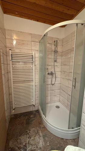 a bathroom with a shower with a glass door at Apartmaji Winter Garden Kranjska Gora in Kranjska Gora