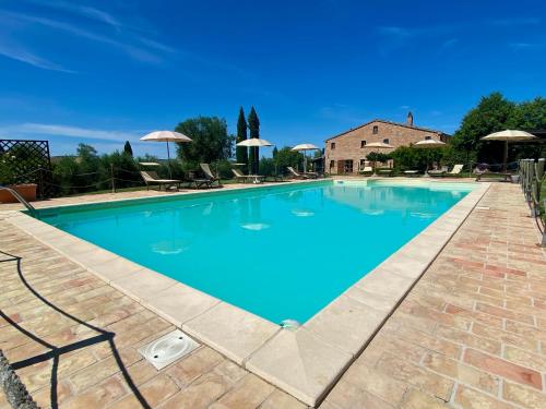 a large swimming pool with blue water at Casalantico in Corinaldo