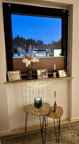 a room with a window with a table and a candle at bergwärts in Bischofsgrün