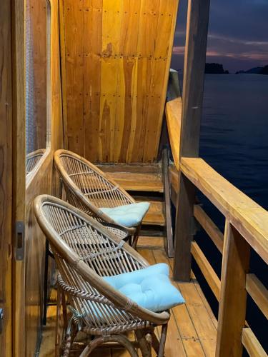 two chairs sitting on a deck of a boat at Luxury Private Phinisi Sailing in Komodo island in Labuan Bajo