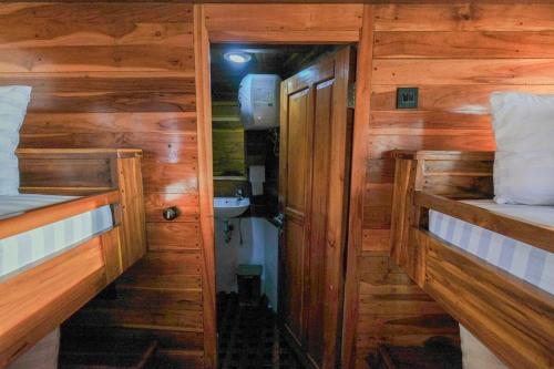 a small room with two bunk beds and a bathroom at Luxury Private Phinisi Sailing in Komodo island in Labuan Bajo